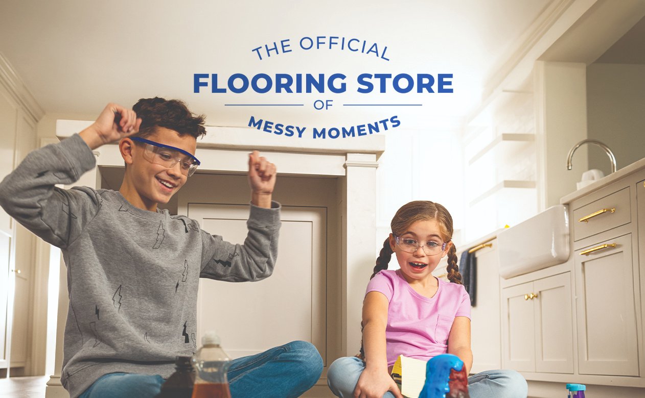 Siblings conducting a science volcano experiment on hardsurface flooring