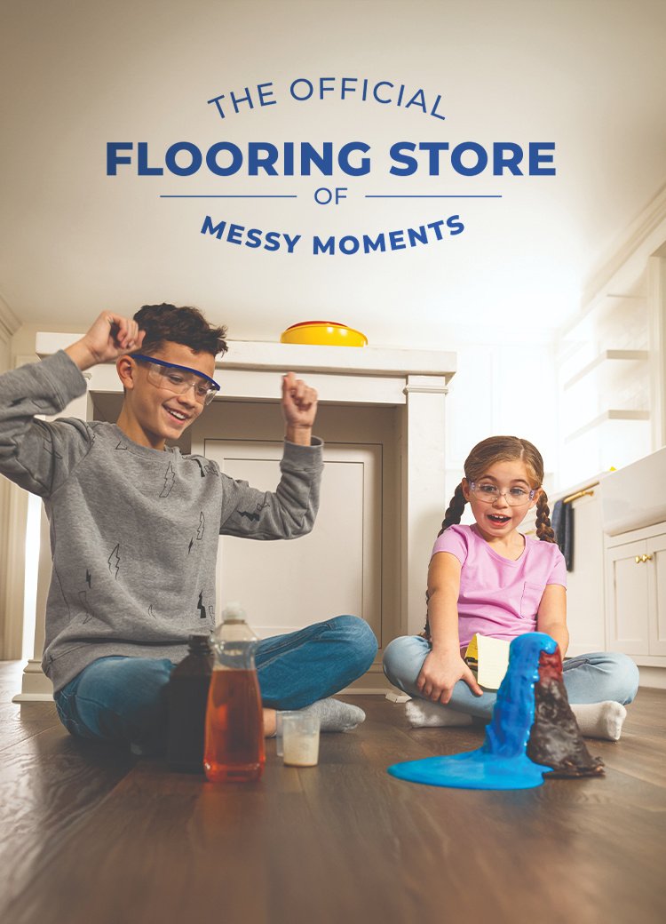 Siblings conducting a science volcano experiment on hardsurface flooring